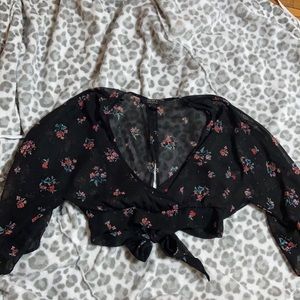 Sheer black top, floral detailing, subtle glitter